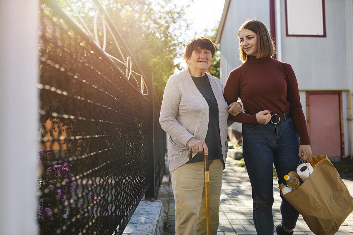 image of a caretaker and her client out grocery shopping