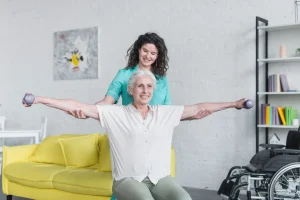 nurse helping senior client lift weights