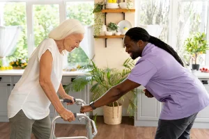 nurse helping elderly woman walk